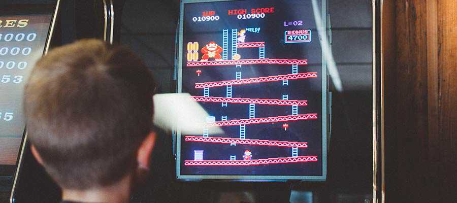 A child plays a game of Donkey Kong.